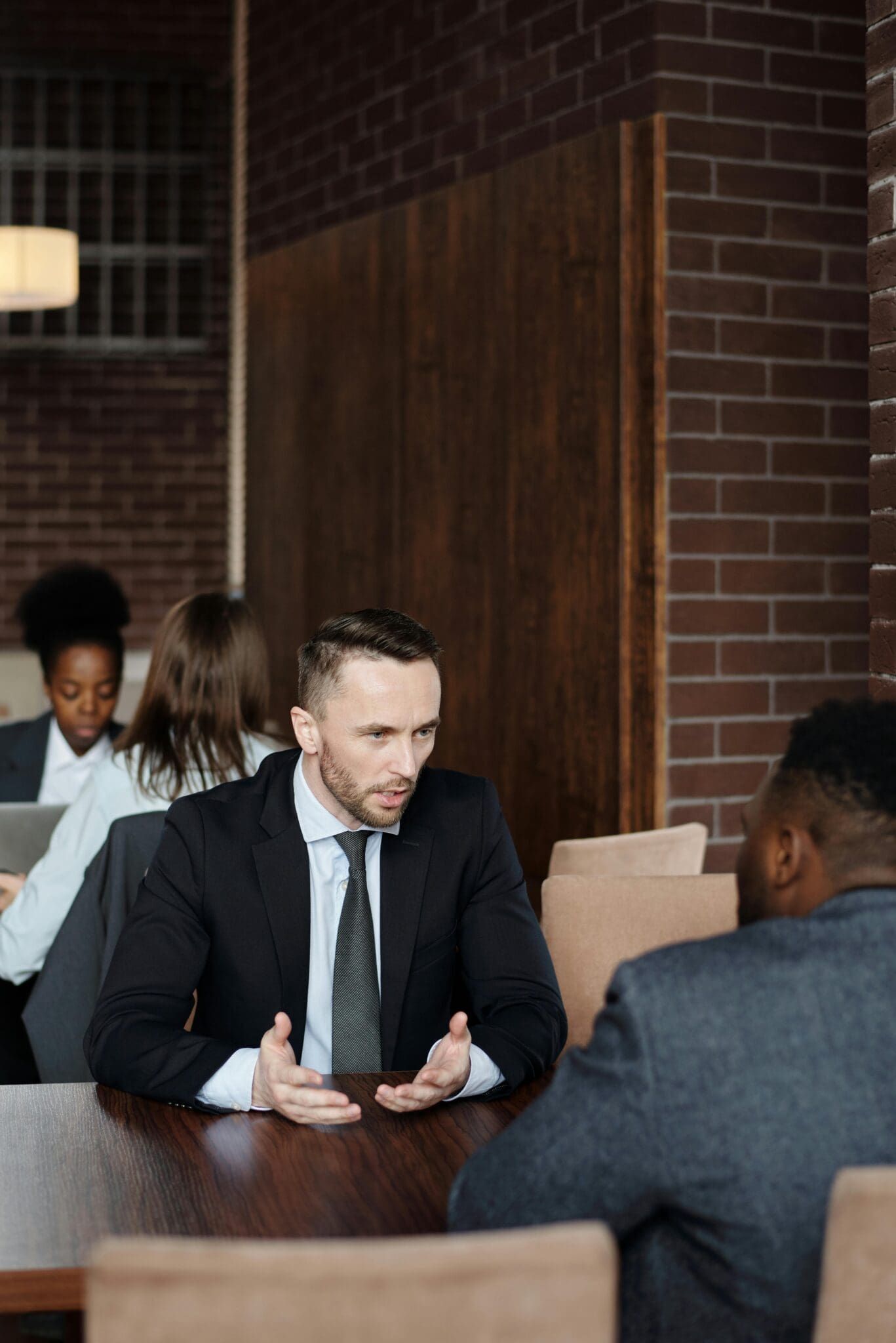 Two men in business suits having a serious discussion in a modern office setting.